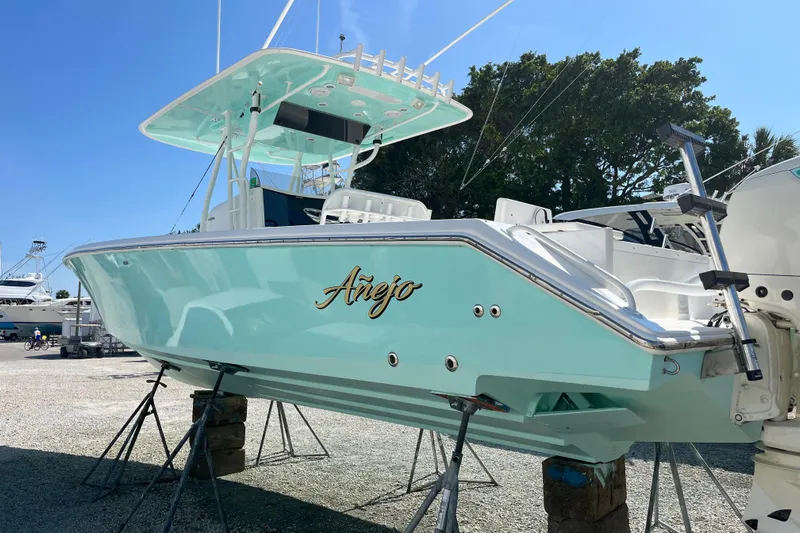  Yacht Photos Pics 2009 Venture 34 Tournament boat in light blue, displayed on stands outdoors.