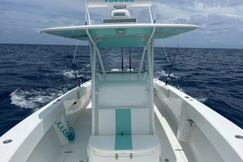  Yacht Photos Pics 2009 Venture 34 Tournament boat on open sea, featuring fishing rods and a clear sky.