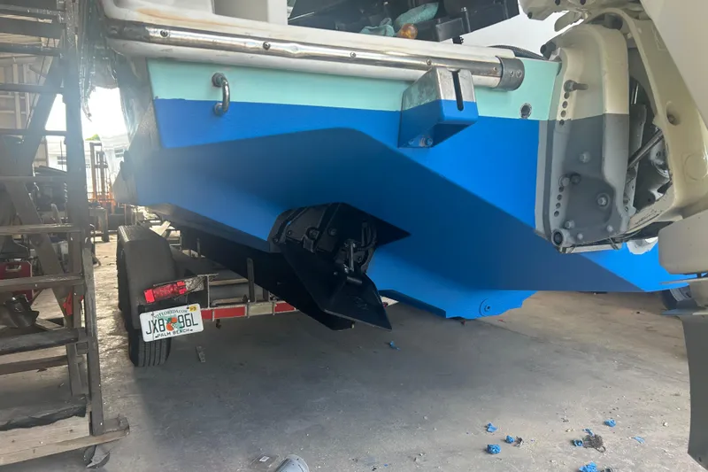  Yacht Photos Pics 2009 Venture 34 Tournament boat on trailer, blue hull, in a garage setting.