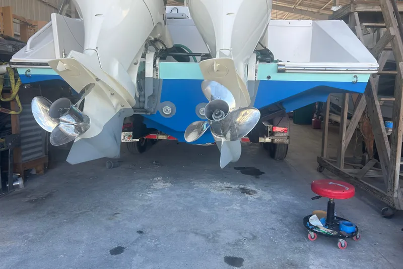  Yacht Photos Pics 2009 Venture 34 Tournament boat with dual outboard engines in a garage setting.