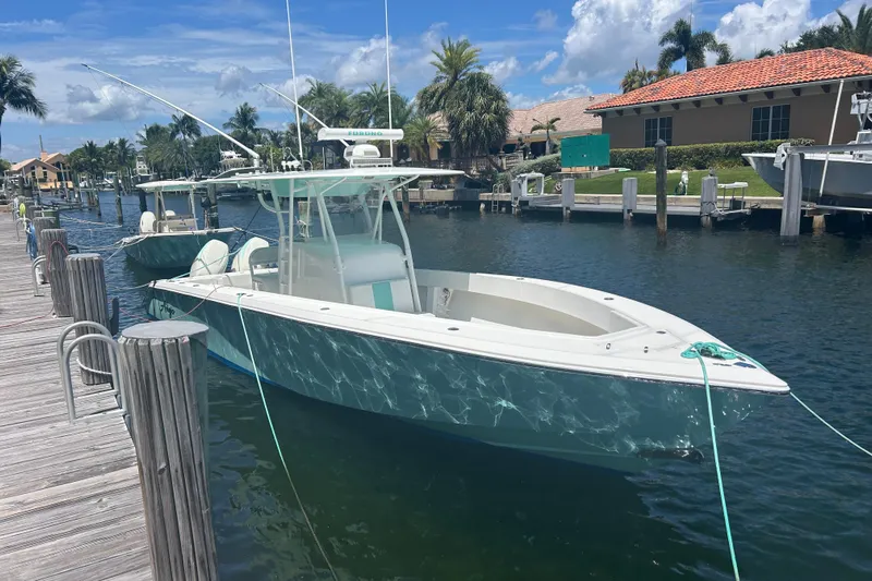  Yacht Photos Pics 2009 Venture 34 Tournament boat docked in sunny marina setting.