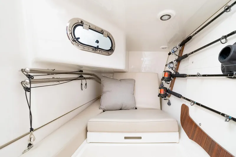 Shep's Ahoy Yacht Photos Pics Interior cabin of 2020 Pursuit DC 326 Dual Console boat with fishing rods and cushion.