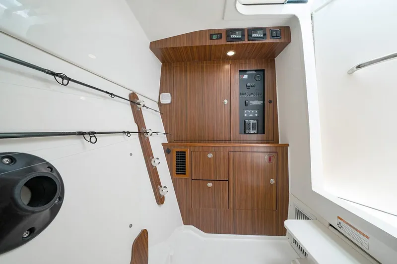 Shep's Ahoy Yacht Photos Pics 2020 Pursuit DC 326 Dual Console interior with wooden cabinetry and fishing rod holders.