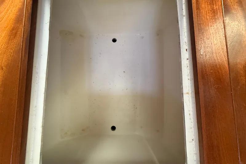  Yacht Photos Pics Empty storage compartment on 2022 Pursuit OS 355 Offshore boat with wooden trim.