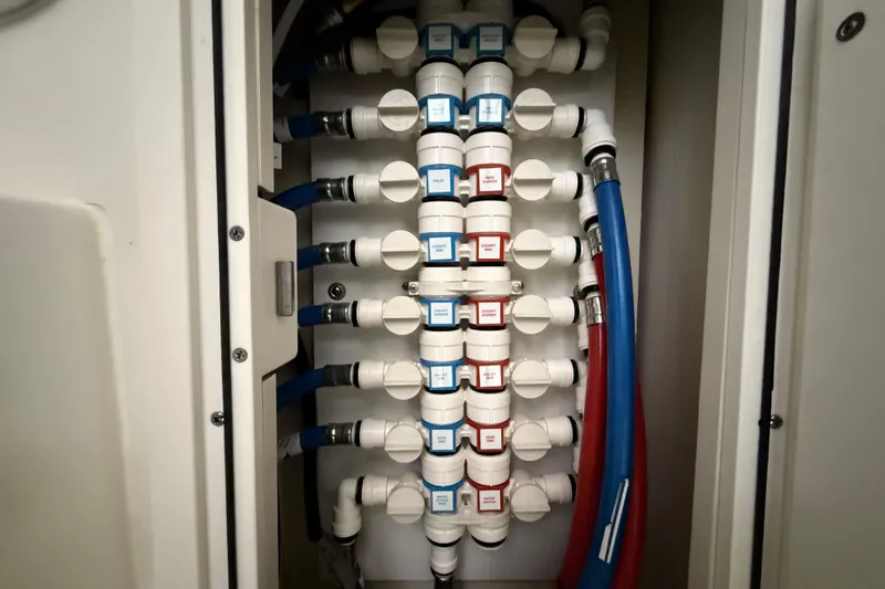  Yacht Photos Pics Plumbing system in 2022 Pursuit OS 355 Offshore boat, featuring labeled pipes and connectors.