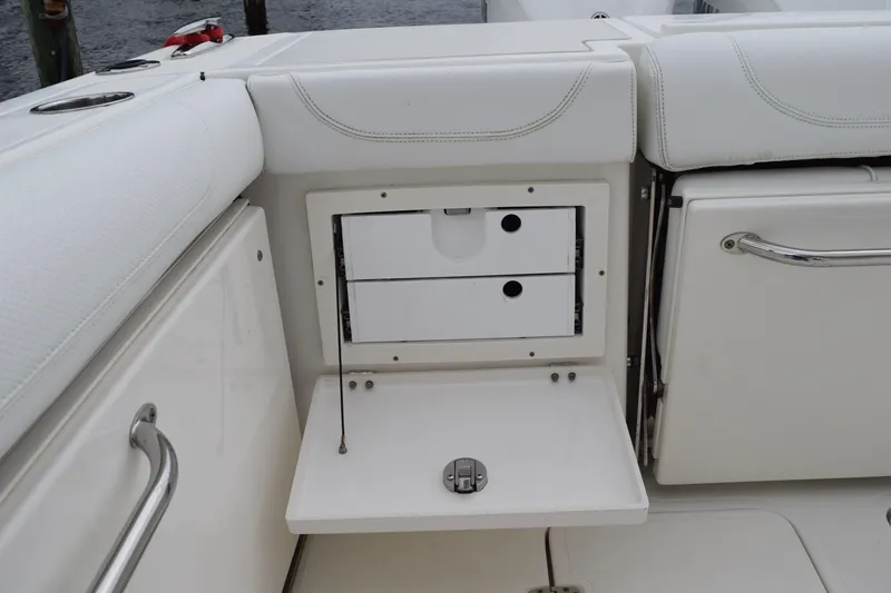  Yacht Photos Pics 2022 Pursuit OS 355 Offshore boat interior storage compartment with white cushioned seating.