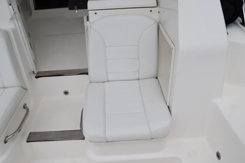  Yacht Photos Pics White seat on 2022 Pursuit OS 355 Offshore boat, featuring sleek design and comfortable upholstery.