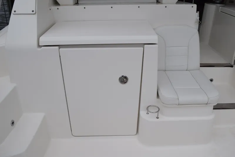  Yacht Photos Pics 2022 Pursuit OS 355 Offshore boat interior with white seating and storage compartment.