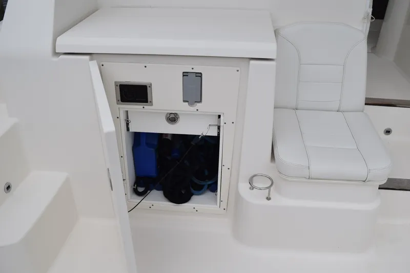  Yacht Photos Pics 2022 Pursuit OS 355 Offshore boat interior with storage compartment and cushioned seat.
