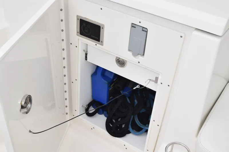  Yacht Photos Pics Storage compartment on 2022 Pursuit OS 355 Offshore boat with ropes and blue container.