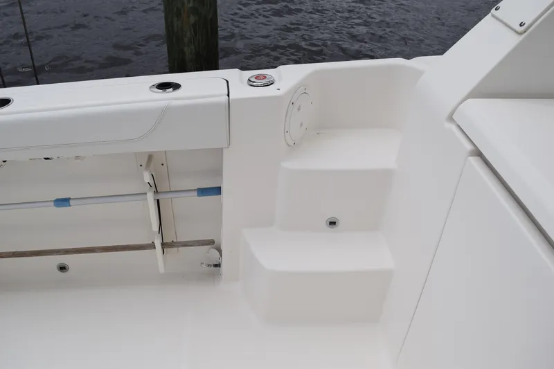  Yacht Photos Pics 2022 Pursuit OS 355 Offshore boat interior with white seating and steps.