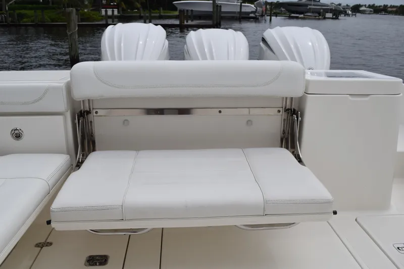  Yacht Photos Pics 2022 Pursuit OS 355 Offshore boat with white cushioned seating and triple outboard motors.