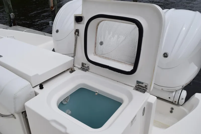  Yacht Photos Pics 2022 Pursuit OS 355 Offshore boat with open storage compartment and twin outboard engines.