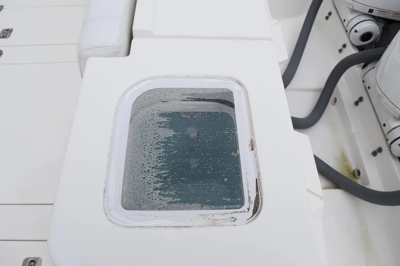  Yacht Photos Pics 2022 Pursuit OS 355 Offshore boat deck with livewell and engine components.