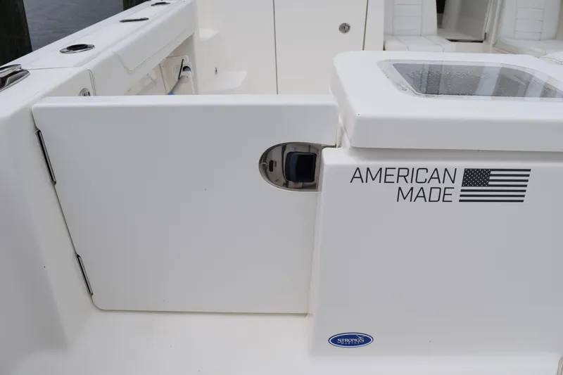  Yacht Photos Pics 2022 Pursuit OS 355 Offshore boat interior with "American Made" label and flag.