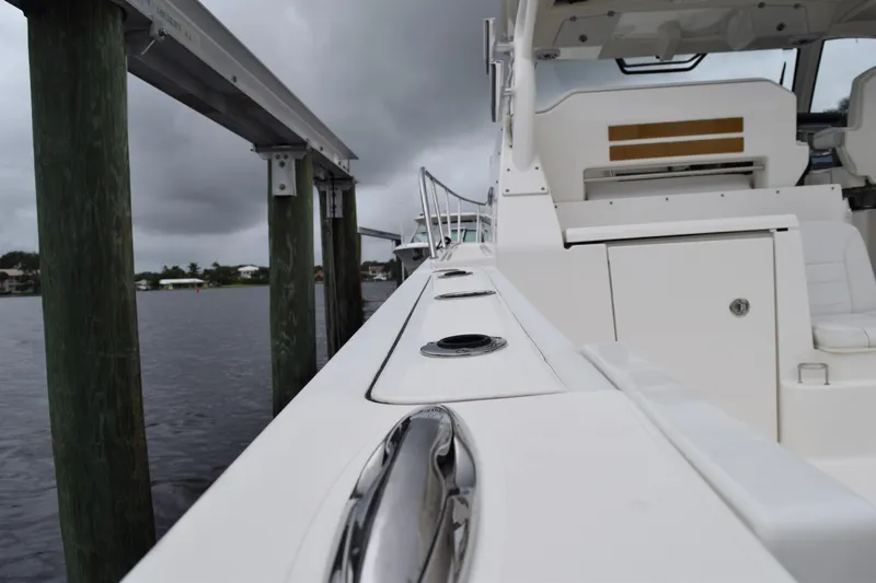  Yacht Photos Pics 2022 Pursuit OS 355 Offshore boat docked, showcasing sleek design and modern features.