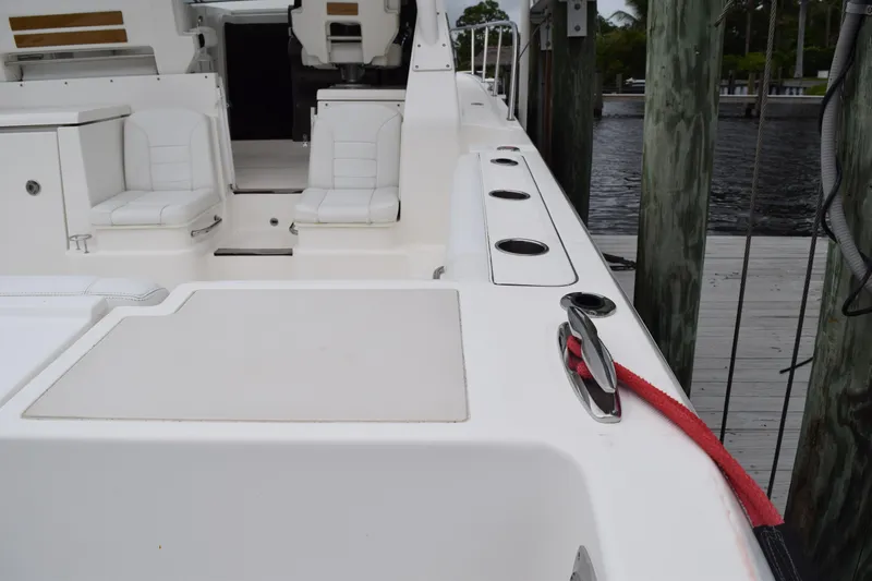  Yacht Photos Pics 2022 Pursuit OS 355 Offshore boat interior with seating and docked at marina.