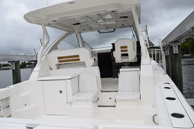  Yacht Photos Pics 2022 Pursuit OS 355 Offshore boat interior with white seating and helm station.