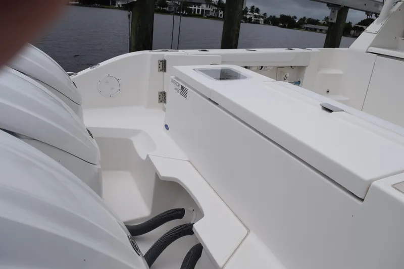  Yacht Photos Pics 2022 Pursuit OS 355 Offshore boat deck with engines, docked by the water.
