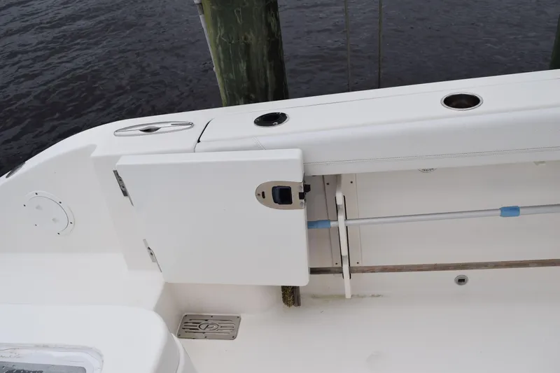  Yacht Photos Pics 2022 Pursuit OS 355 Offshore boat deck with storage compartment and rod holder.