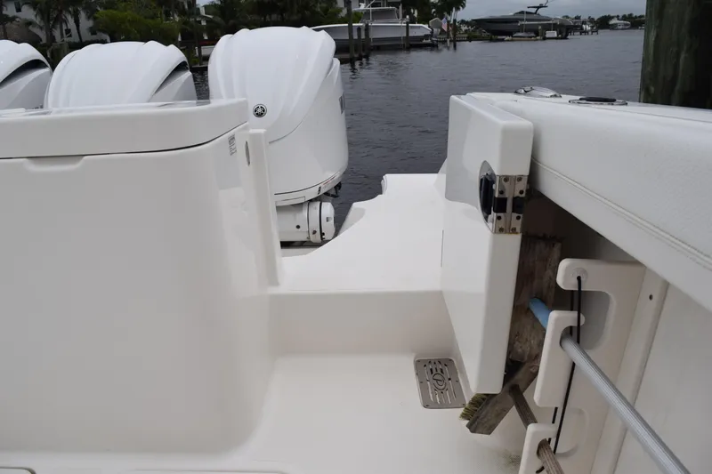  Yacht Photos Pics 2022 Pursuit OS 355 Offshore boat with outboard motors docked by the water.