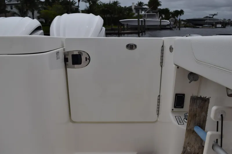  Yacht Photos Pics 2022 Pursuit OS 355 Offshore boat deck with storage compartment and seating.