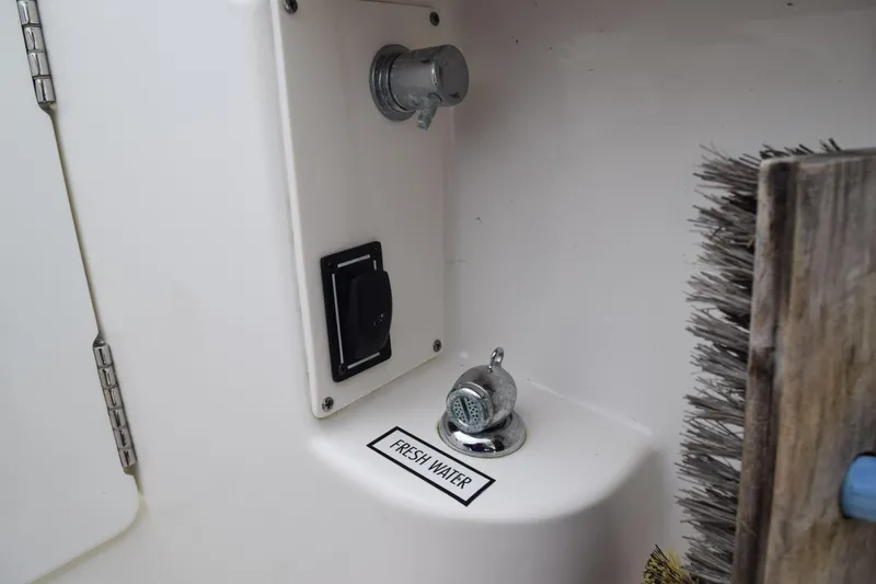  Yacht Photos Pics Freshwater outlet on 2022 Pursuit OS 355 Offshore boat with brush nearby.