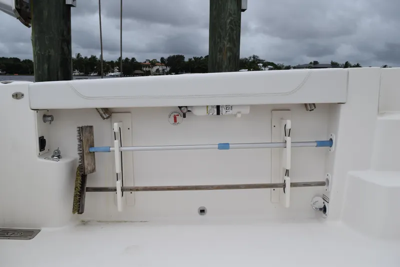  Yacht Photos Pics 2022 Pursuit OS 355 Offshore boat storage compartment with cleaning tools and equipment.