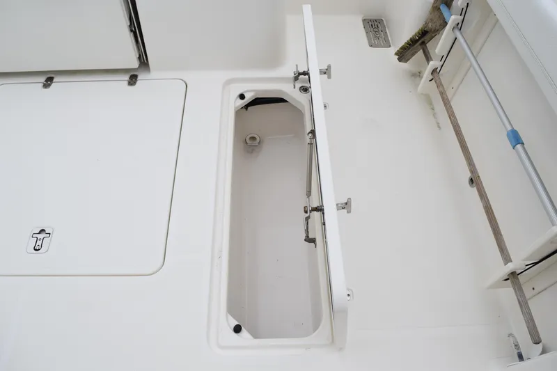  Yacht Photos Pics 2022 Pursuit OS 355 Offshore boat storage compartment with open hatch.