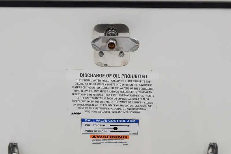  Yacht Photos Pics 2022 Pursuit OS 355 Offshore warning label prohibiting oil discharge, featuring ball valve control instructions.