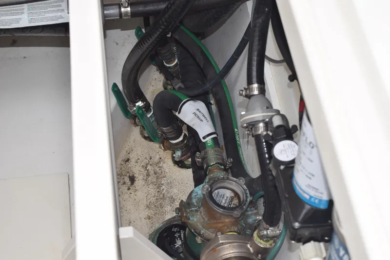  Yacht Photos Pics 2022 Pursuit OS 355 Offshore engine compartment with hoses and valves.