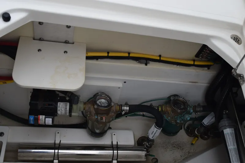  Yacht Photos Pics 2022 Pursuit OS 355 Offshore engine compartment with wiring and mechanical components.