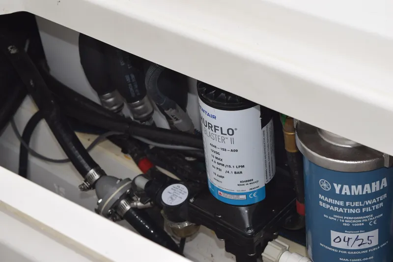  Yacht Photos Pics 2022 Pursuit OS 355 Offshore engine compartment with Yamaha marine fuel filter and Shurflo pump.