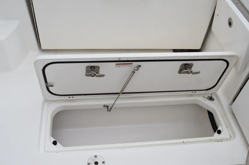  Yacht Photos Pics 2022 Pursuit OS 355 Offshore storage compartment with open hatch and secure latches.