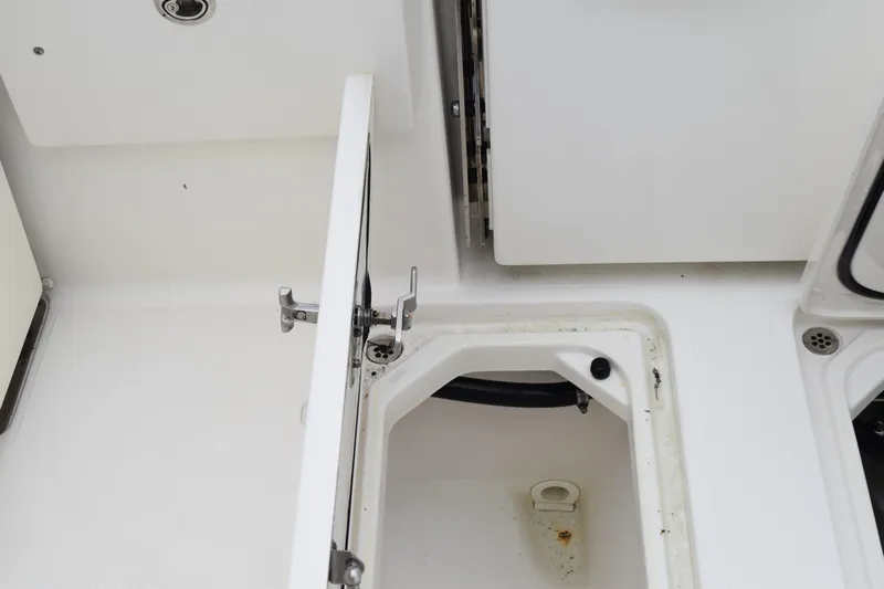  Yacht Photos Pics 2022 Pursuit OS 355 Offshore boat storage compartment with open hatch.