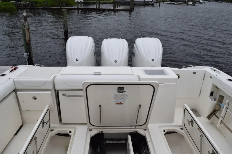  Yacht Photos Pics 2022 Pursuit OS 355 Offshore boat with triple outboard engines at dock.