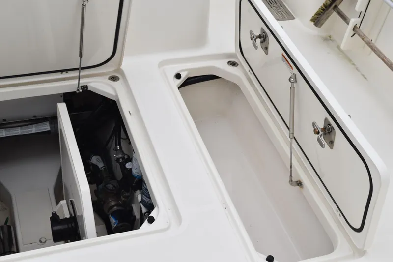  Yacht Photos Pics 2022 Pursuit OS 355 Offshore boat storage compartments with open hatches and visible equipment.