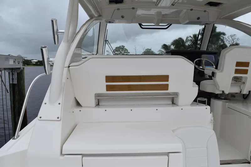  Yacht Photos Pics 2022 Pursuit OS 355 Offshore boat interior with seating and steering wheel.