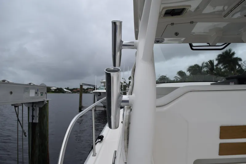  Yacht Photos Pics 2022 Pursuit OS 355 Offshore boat docked, featuring stainless steel rod holders.