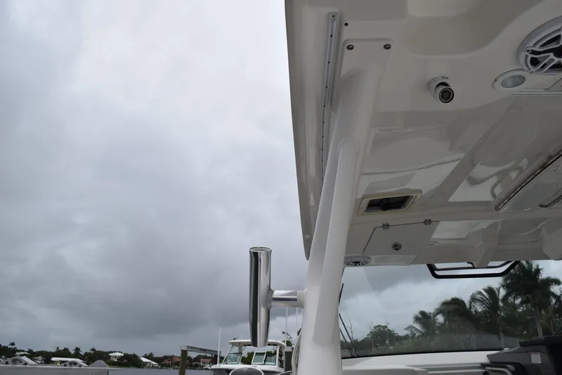  Yacht Photos Pics 2022 Pursuit OS 355 Offshore boat under cloudy sky, showcasing sleek design and structure.