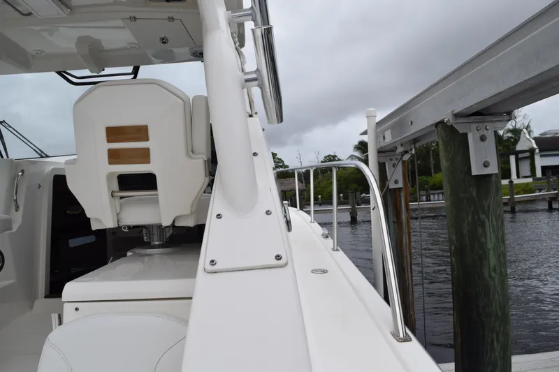  Yacht Photos Pics 2022 Pursuit OS 355 Offshore boat docked, featuring sleek design and modern seating.