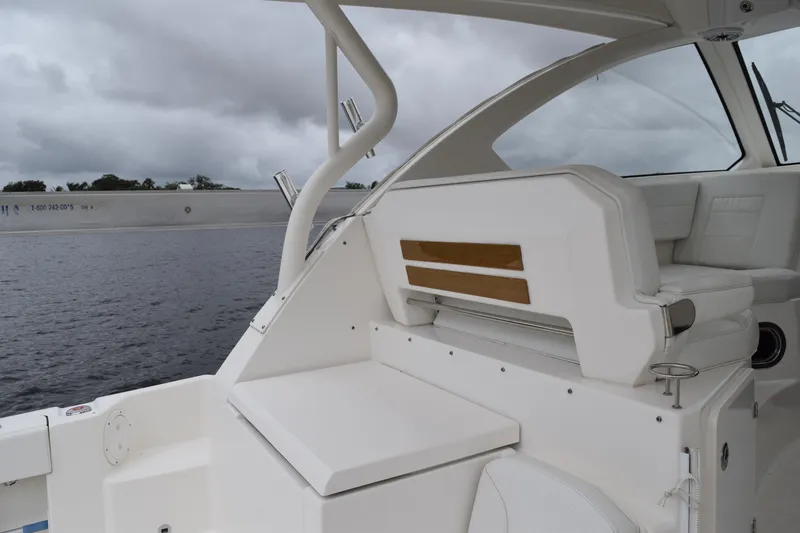  Yacht Photos Pics 2022 Pursuit OS 355 Offshore boat interior with white seating and wooden accents.