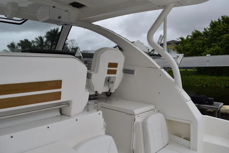  Yacht Photos Pics 2022 Pursuit OS 355 Offshore boat interior with white seating and wooden accents.