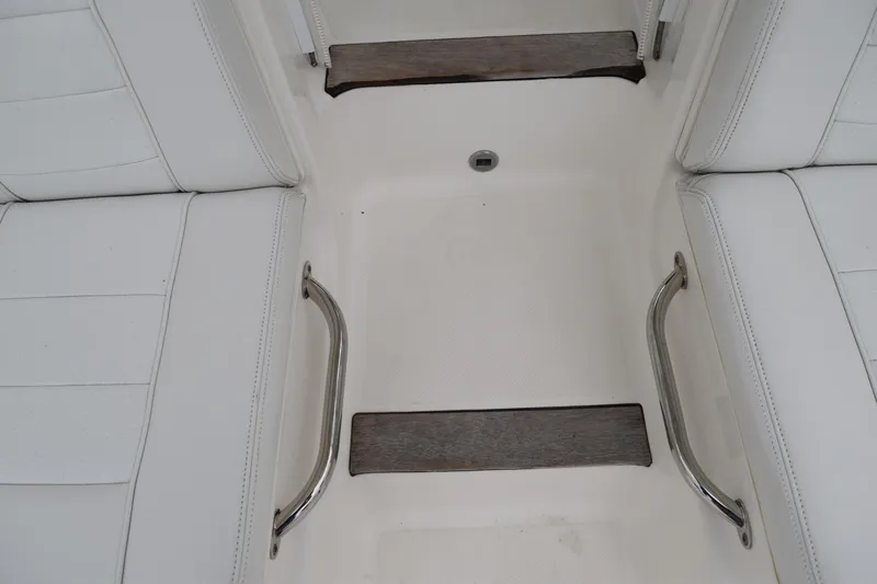  Yacht Photos Pics 2022 Pursuit OS 355 Offshore boat interior with white seating and metal handles.