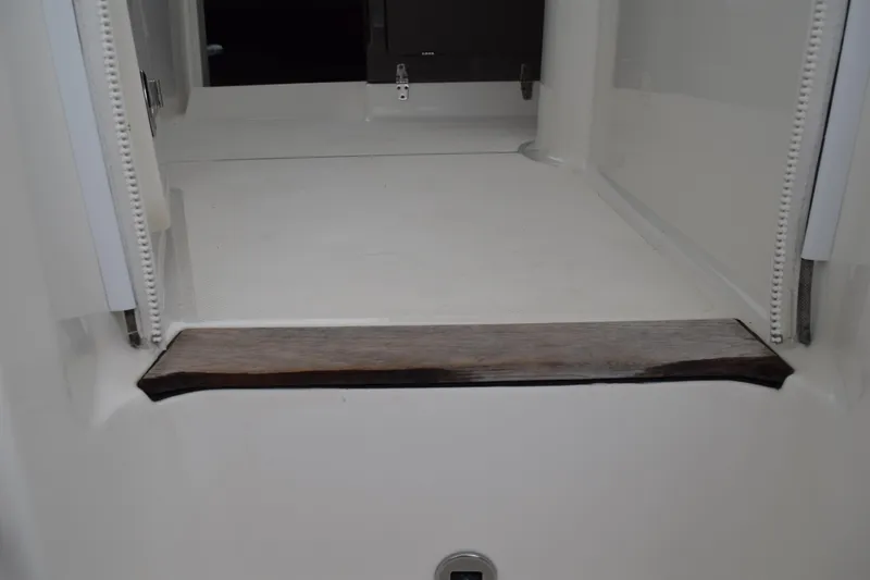  Yacht Photos Pics 2022 Pursuit OS 355 Offshore boat interior with wooden step detail.