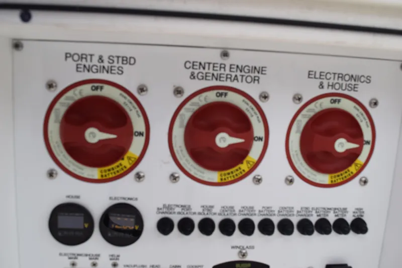  Yacht Photos Pics Control panel of a 2022 Pursuit OS 355 Offshore boat, featuring engine and electronics switches.