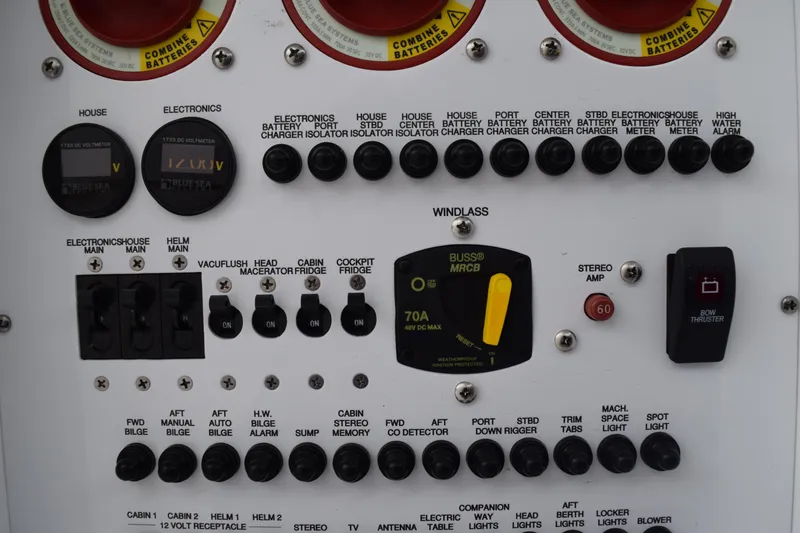  Yacht Photos Pics Control panel of a 2022 Pursuit OS 355 Offshore boat with various switches and indicators.