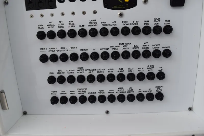  Yacht Photos Pics Control panel of a 2022 Pursuit OS 355 Offshore boat with labeled switches.