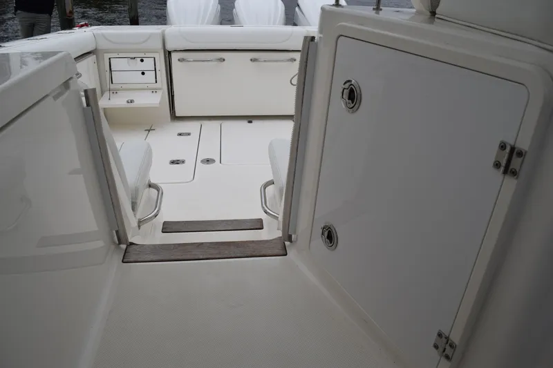  Yacht Photos Pics 2022 Pursuit OS 355 Offshore boat interior with storage compartments and seating.