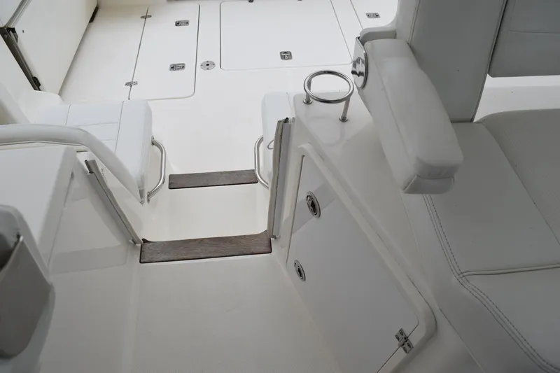  Yacht Photos Pics 2022 Pursuit OS 355 Offshore boat interior with white seating and storage compartments.